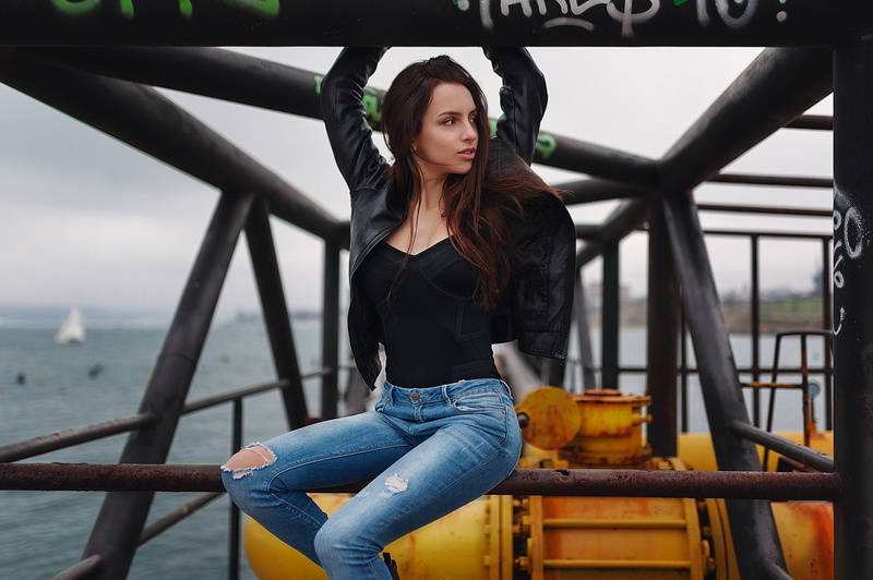 contemplation, beauty, beautiful woman, casual clothing, front view, jeans, focus on foreground, portrait, adult, torn jeans, railing, lifestyles, outdoors