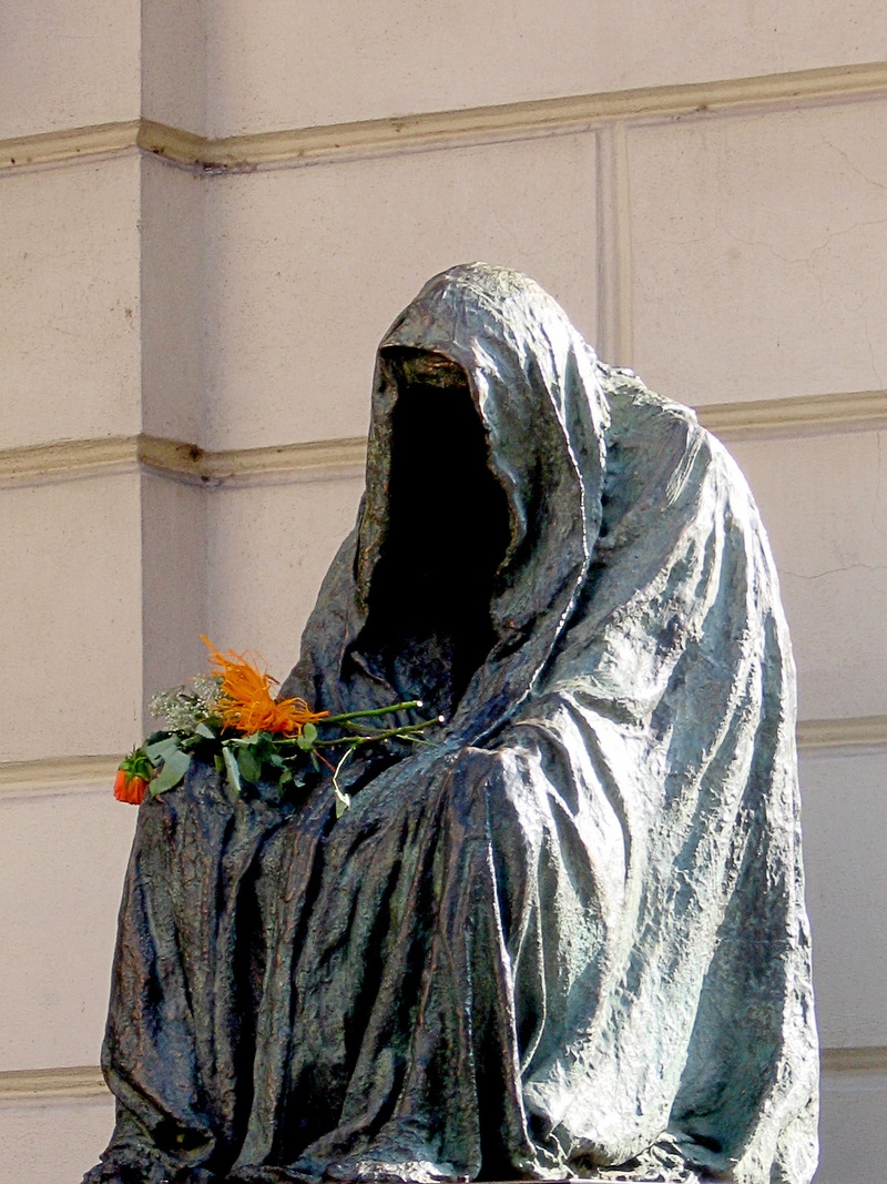 belief, built structure, one woman only, coat, spirituality, close-up, cultures, gloomy, figure, mozart memorial, adult, bronze, statue, art, day, wall - building feature