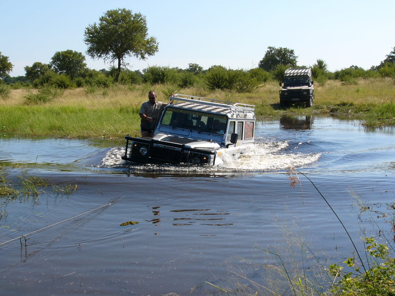 transportation, nautical vessel, okavango delta, body, safari, sunlight, truck, nature, river, land vehicle, adventure worlds, motor vehicle, off road travel