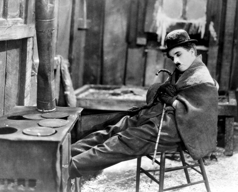 Movie, adult, The Gold Rush, lifestyles, real people, seat, young women, leisure activity, men, Charlie Chaplin, young adult, chair, contemplation, activity