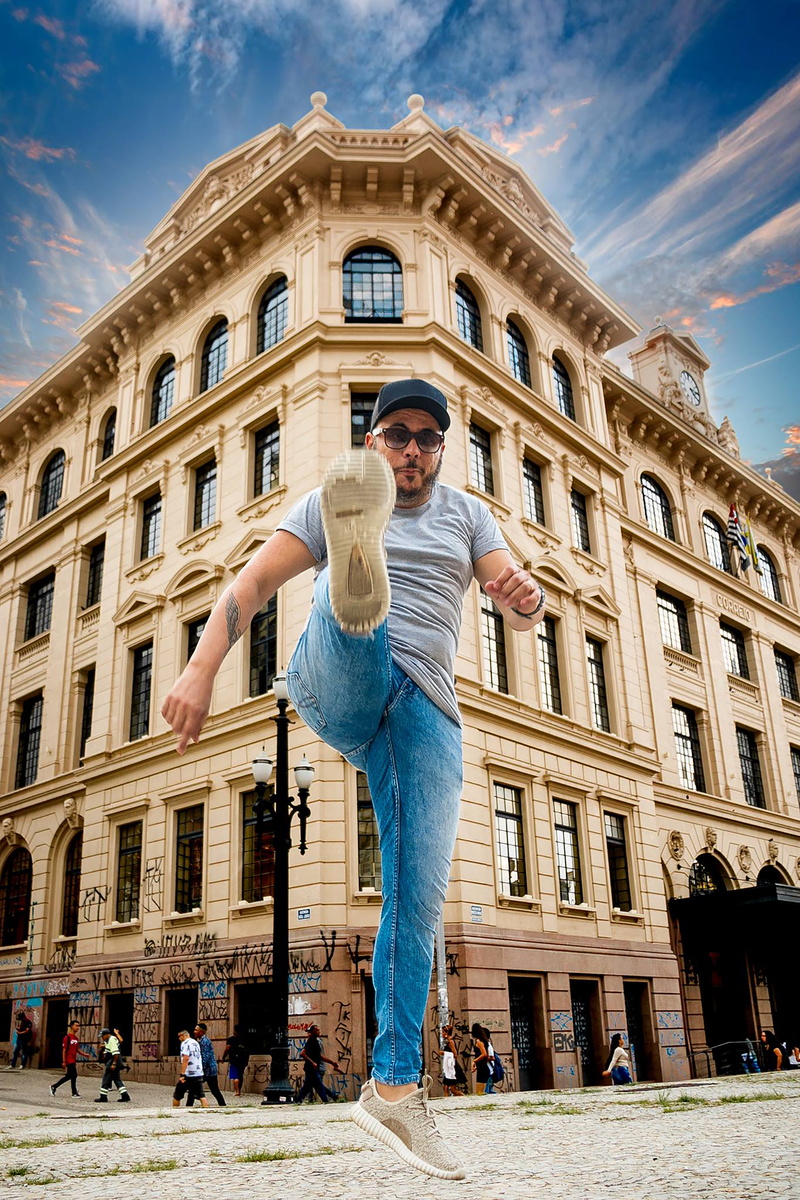 outdoors, square, tourist, built structure, low angle view, leisure activity, downtown, front view, facade, town, man, building exterior, building, sky