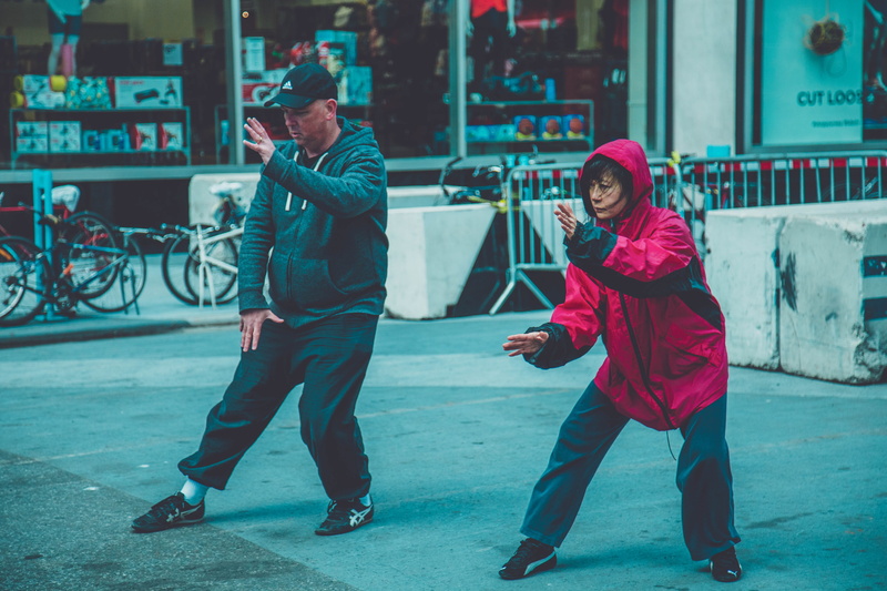 women, martial, real people, recreation, city, blur, adult, fit, leisure activity, woman, activity, warm clothing, focus, winter, standing, pavement, fashion