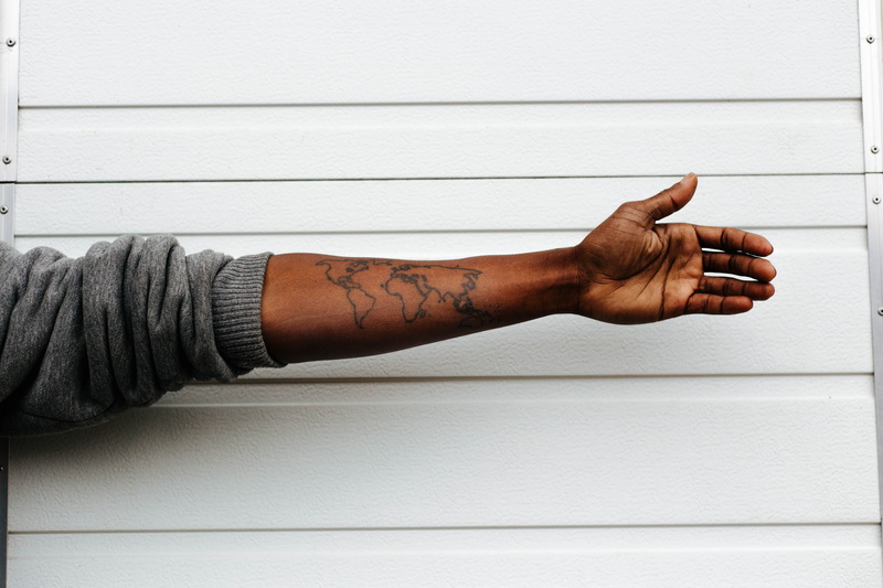 wall - building feature, human body part, creativity, indoors, human Arm, adult, man, body part, raising, world, arm, map, painted, men, wood - material