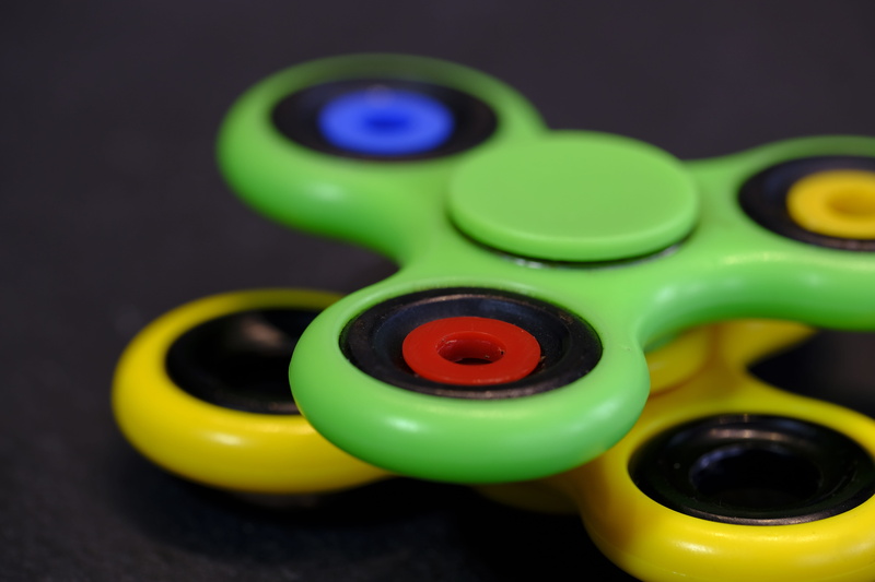 movement, plastic, fidget spinner, selective focus, play, circle, turn, studio shot, no people, rotation, spinner, technology, group of objects, multi colored