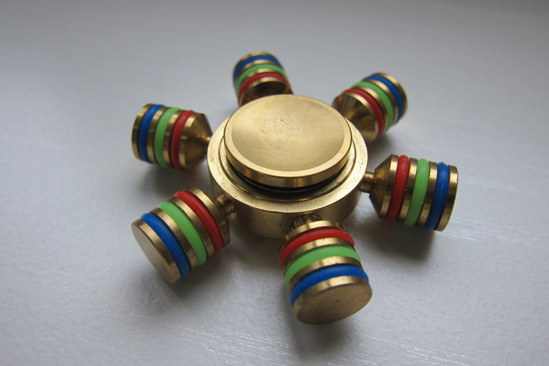 art and craft, fidget spinner, still life, roller, entertainment, finger, large group of objects, hobby, anxiety, play, focus, choice, striped, high angle view