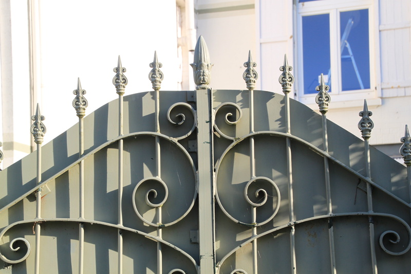 door, shape, outdoors, pointed, iron gate, nature, sky, built structure, pattern, window, day, architecture, ornaments, facade, wrought iron, metal fence