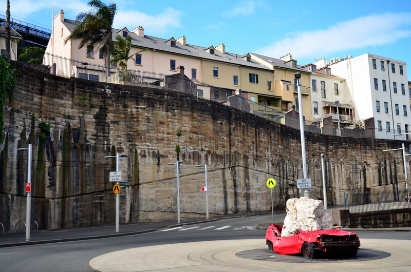 building, outdoors, architecture, motor vehicle, cloud - sky, wall, car, sky, the rocks, mode of transportation, transportation, sunlight, houses, residential district