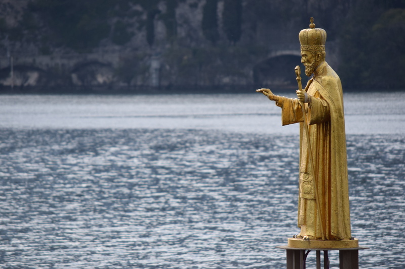 bird, focus on foreground, religion, representation, human representation, sculpture, art and craft, sea, lake, animal wildlife, statue, gold colored, lombardy
