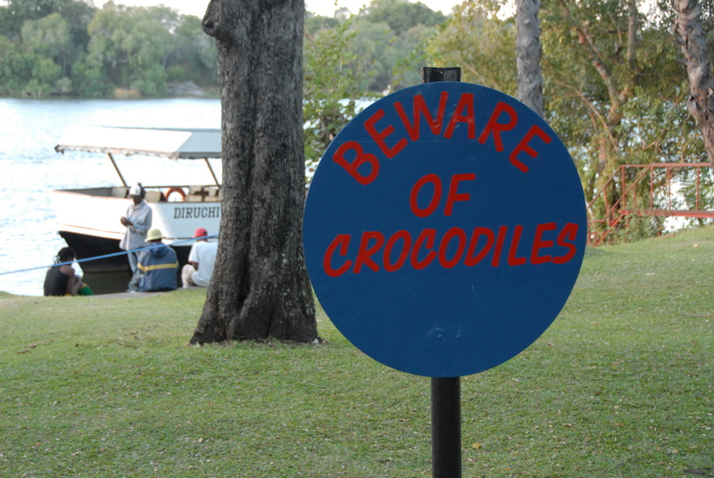 sign, outdoors, trunk, zambezi river, park, transportation, zambia, park - man made space, field, tree, communication, mode of transportation, text, information