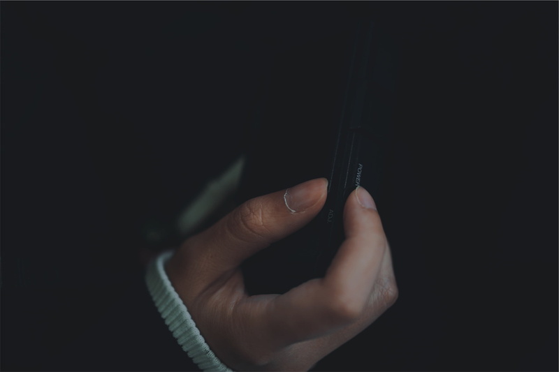 selective focus, plastic, holding, 1080P, hand, studio shot, human limb, nokia, lifestyles, copy space, person, dark, communication, smartphone, adults only