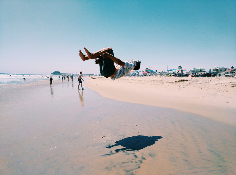 water, shorts, handstand, clear sky, human, real people, beach, newport beach, full length, clothing, outdoors, vertebrate, man, one person, shoreline