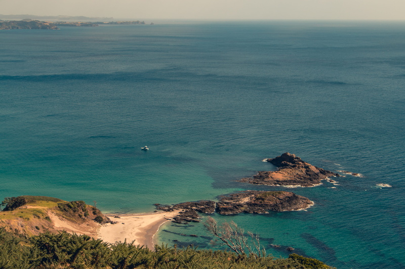 land, ocean beach, east coast, no people, ocean, tranquility, water, boat, sea, cliff, horizon, rocky coastline, day, rock - object, idyllic, scenics - nature