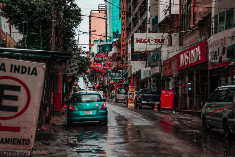 sign, background, rain, built structure, wet, communication, building, car, red, motion, road, motor vehicle, ciudad del este, photographer