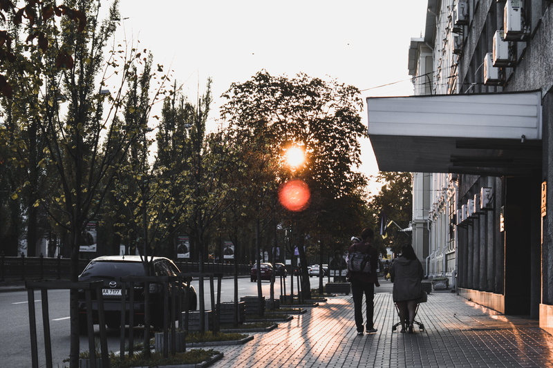 person, lifestyles, street, urban, people, real people, sunset, cars, town, sky, rear view, day, plant, outdoors, 5K, city, sidewalk, tree, nature, sunrise