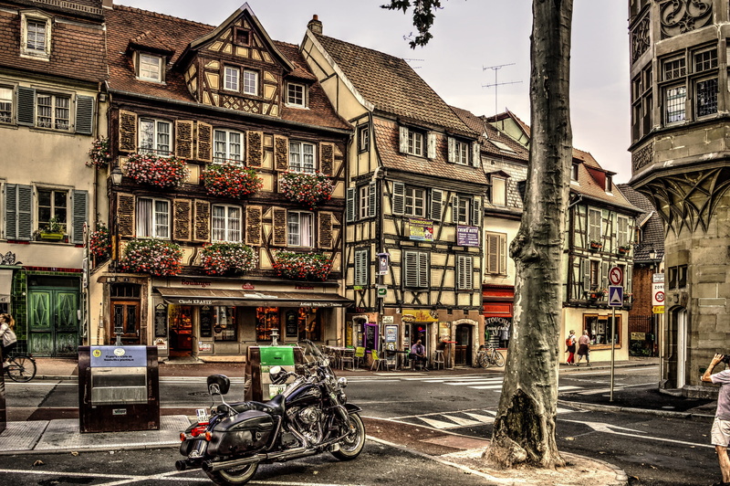 city, transportation, timber-framed, residential district, street, motor vehicle, incidental people, road, outdoors, building, city life, bicycle, travel destinations