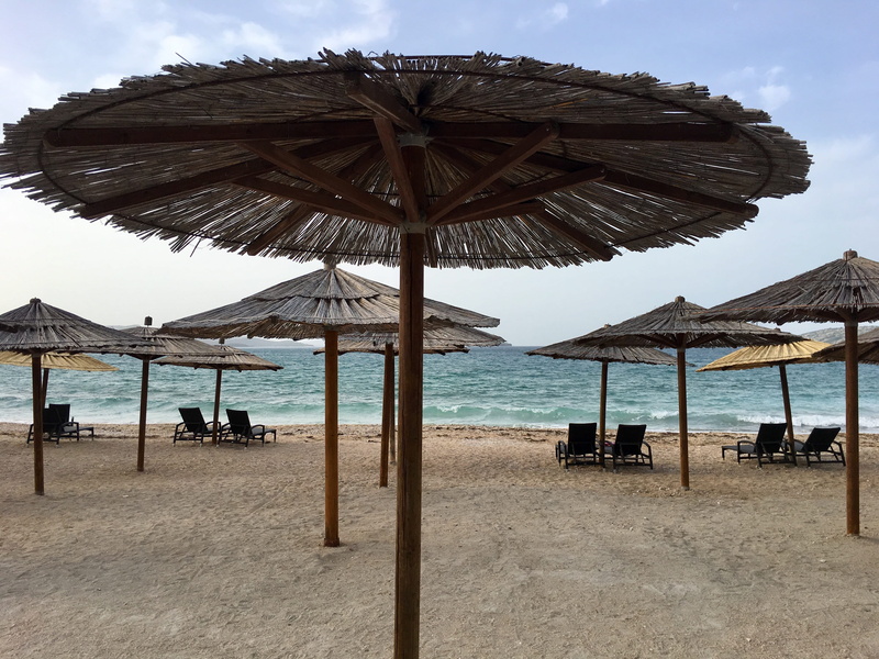 sand, patio umbrella, patio, pergola, tranquil scene, land, sky, horizon over water, tropical, unnamed road, garden umbrella, sea, beach umbrella, nature
