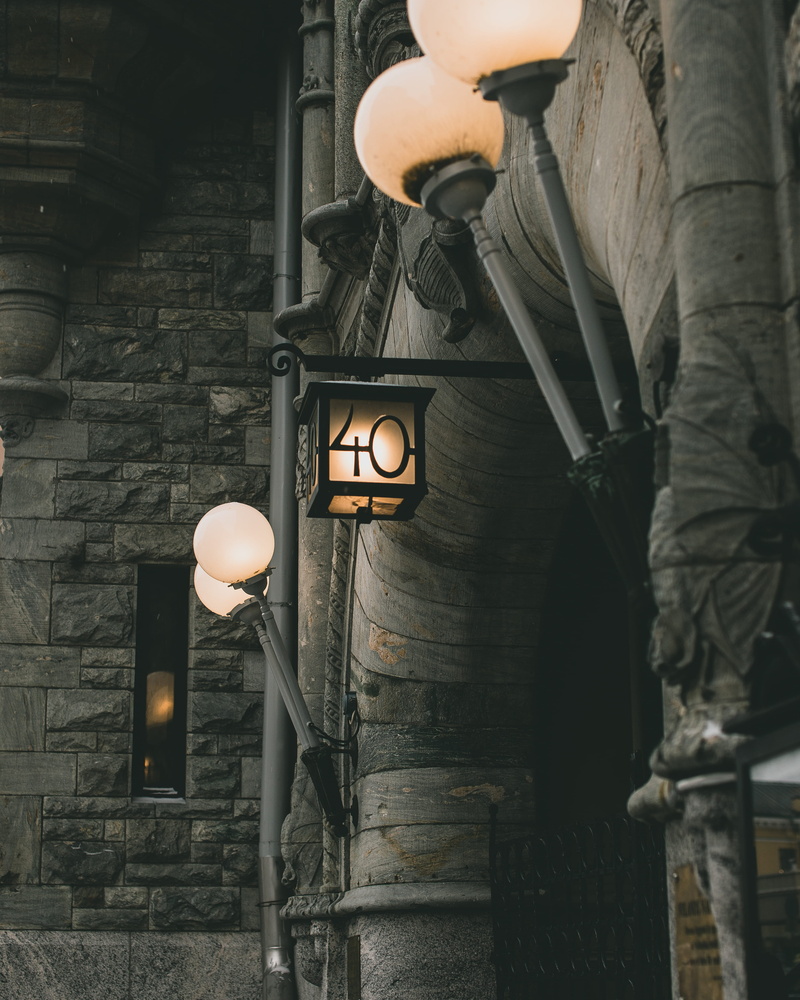 lampshade, built structure, lantern, wall - building feature, tower, lamp post, illuminated, lifestyles, walkway, light, human, street light, steeple, crypt