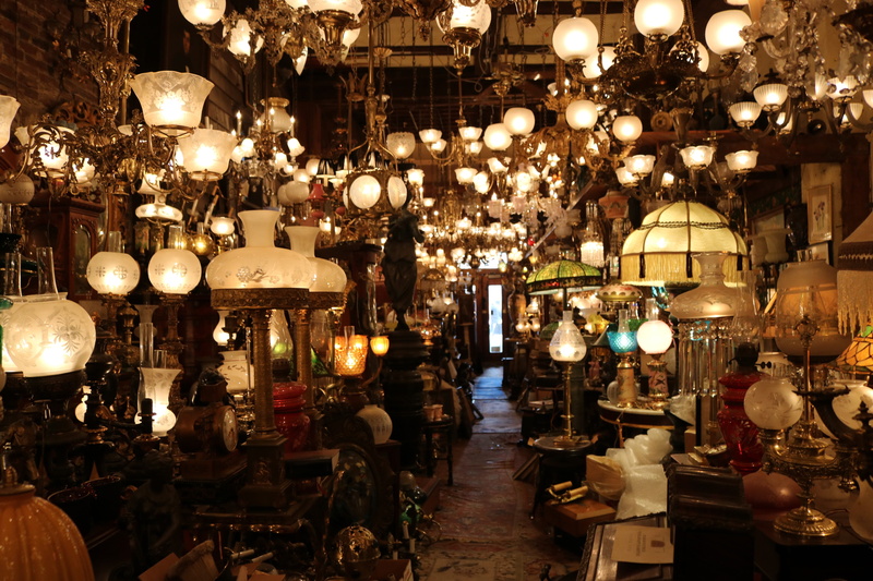 hanging, 5K, large group of objects, wheel, antique shop, night, machine, lights, store, antique, shop, antiques, cafe, building, lighting, spoke, lighting equipment