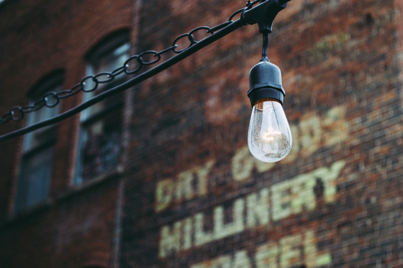 hanging, urban, wall - building feature, city, light bulb, glass - material, electricity, iron, lighting equipment, light, retro, building exterior, turned