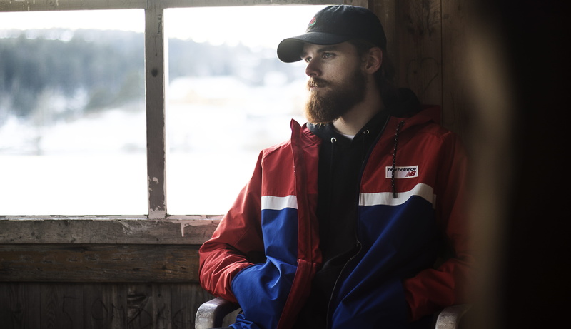 one person, sitting, looking away, facial hair, photoshoot, indoors, cap, standing, outdoors, contemplation, color, leisure activity, man, jacket, real people