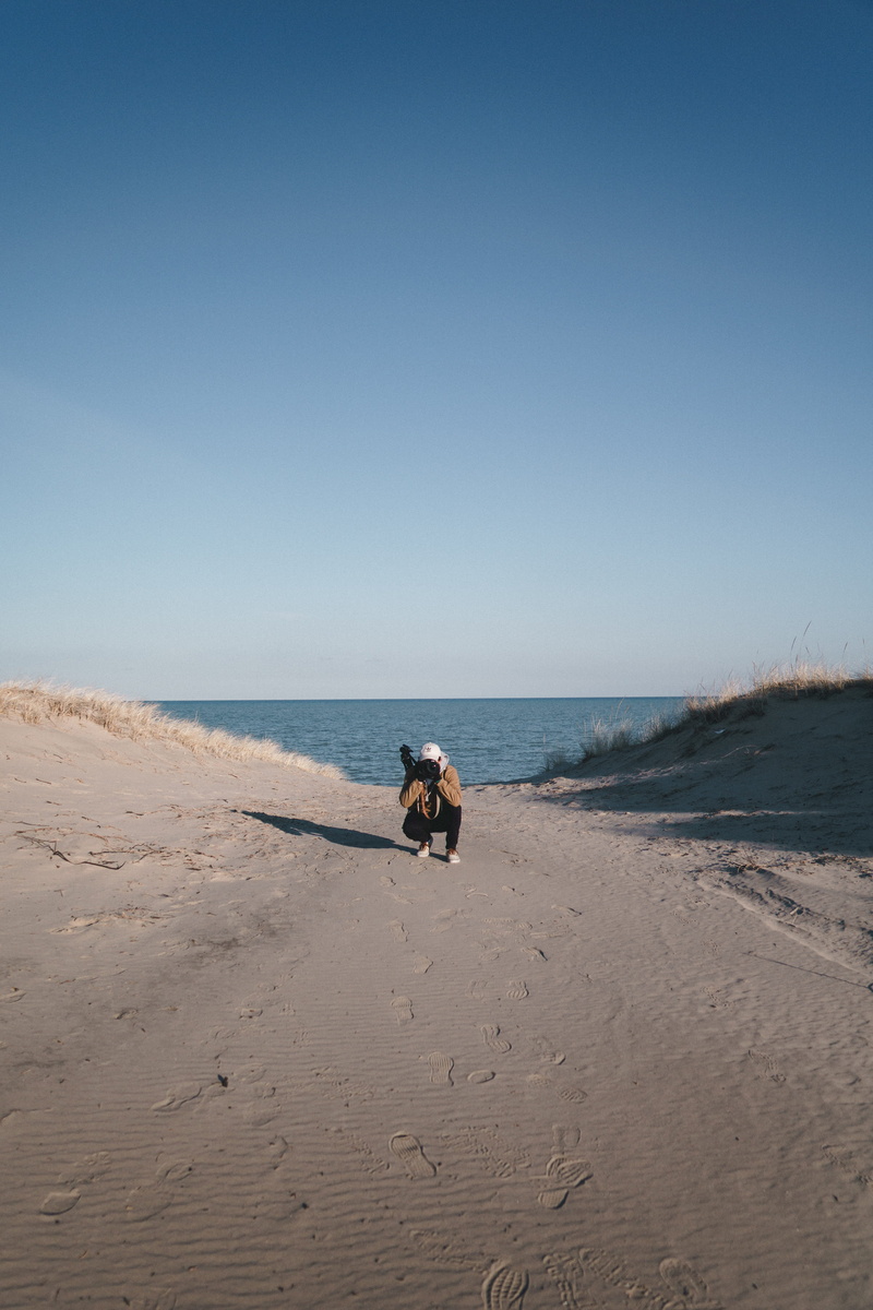 sand, photographer, pet owner, brown, pets, jacket, path, white, camera, nature, 5K, walking, shoes, full length, horizon, land, crouch, gradient, taking photo