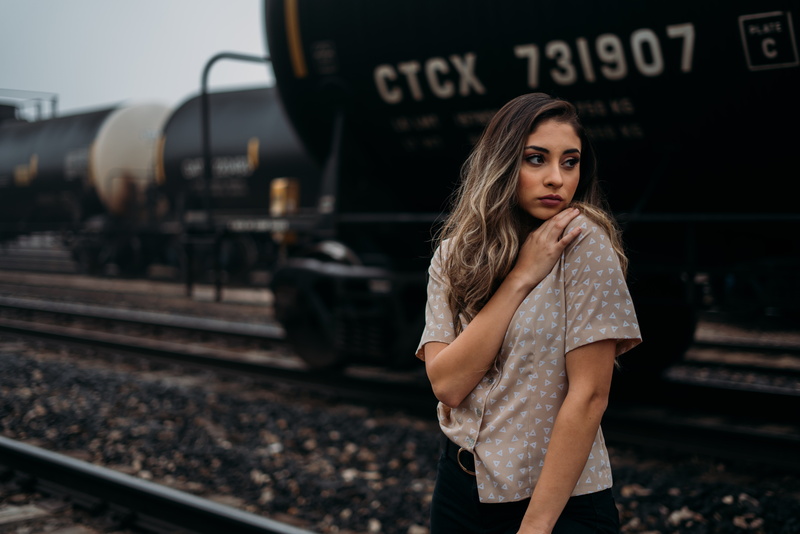 track, gown, standing, railroad track, real people, railroad station, shipping container, travel, fashion, young adult, long sleeve, train, woman, robe
