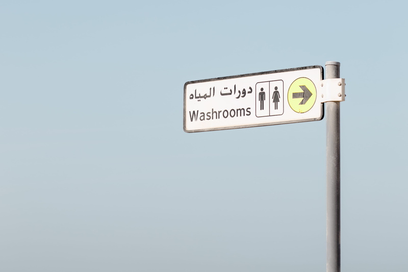 signboard sign, sign, guidance, communication, kite beach, indoors, tag, information, arrow symbol, board, clear sky, entrance, single object, close-up