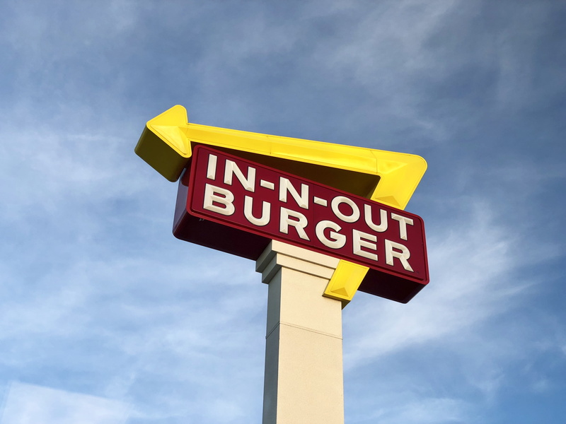 store, western script, sign, blue, yellow, guidance, communication, fast food, low angle view, 4K, n, cloud - sky, symbol, arrow symbol, restaurant, sky