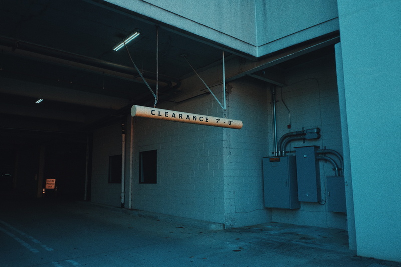 indoors, machine, signboard, electrical device, pipe - tube, text, burner, concrete, garage, sign, factory, ceiling, pergola, floor, lighting equipment