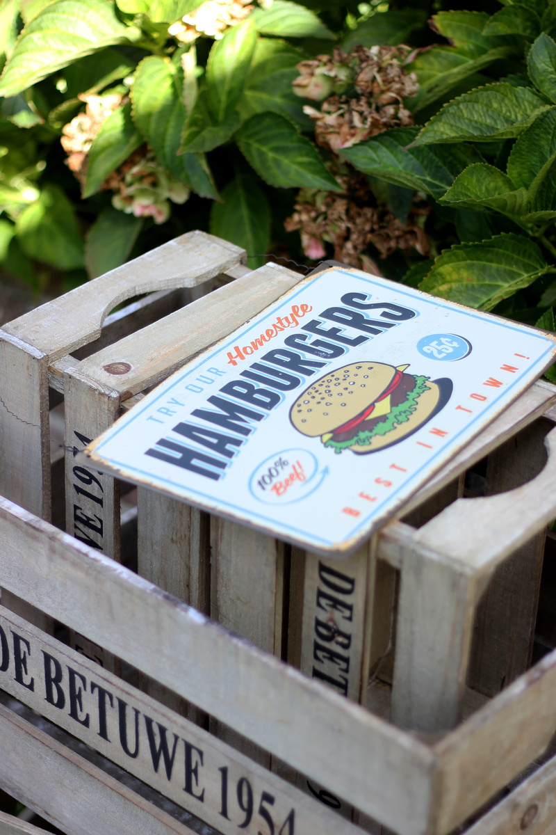 crate, food market, vintage sign, close-up, focus on foreground, illustration, hamburgers, front or back yard, wood, wooden box, wooden crate, plant, day