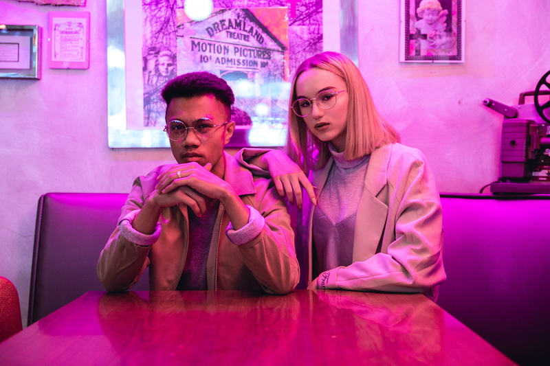 glasses, table, adult, sitting, finger, waist up, people, portrait, jacket, wearing, fashion, couple - relationship, two people, home decor, night club