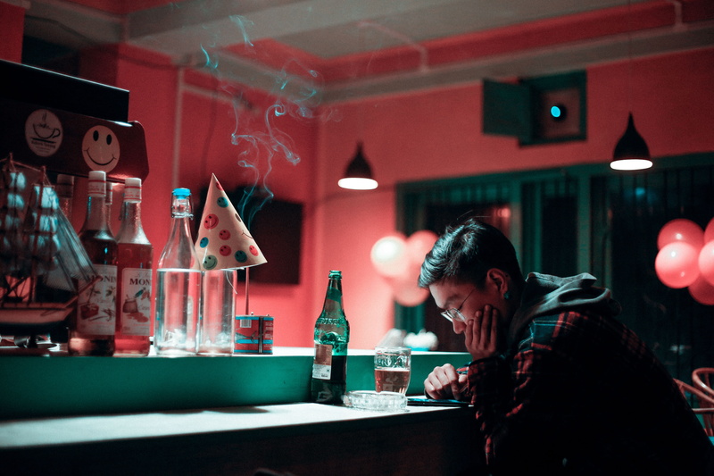 person, bottle, holding, indoors, alcohol, face, guy, drinking glass, liquor, sitting, human, restaurant, glass, club, party, bar, nightlife, 5K, pub