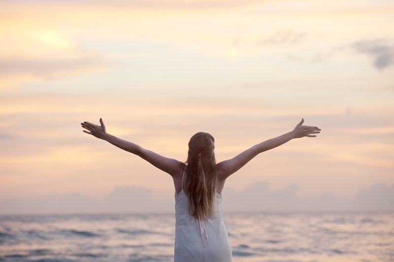 hairstyle, travel, hands, body, human limb, wellbeing, sky, body part, standing, women, arms raised, back, rear view, horizon, beach, sunset, limb, one woman only