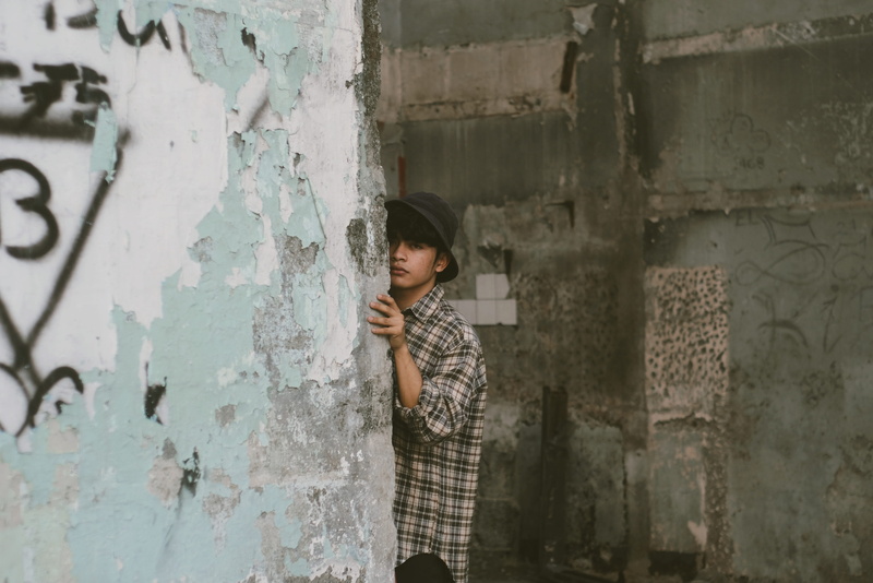 childhood, graffiti, adolescence, building, child, casual clothing, wall - building feature, real people, young adult, behind, concrete, deterioration