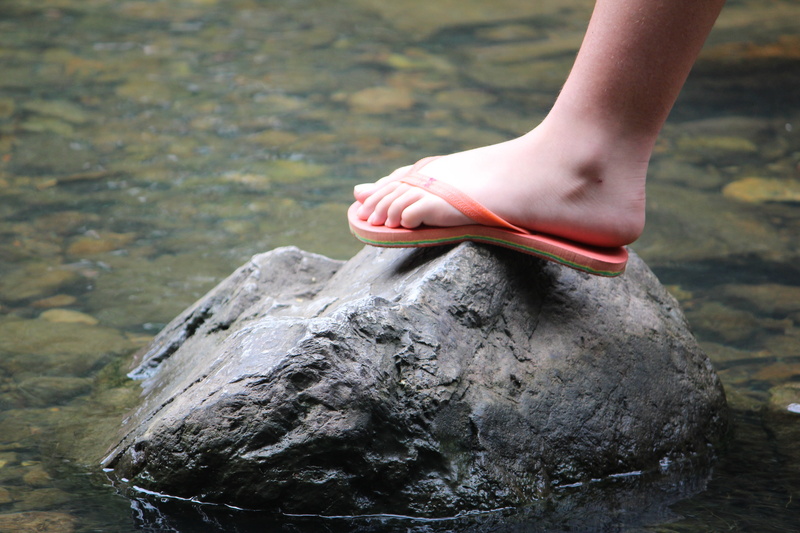 standing, human body part, outdoors, low section, water and stones, rock, hand, rock - object, day, thongs, human leg, human limb, nature, one person, finch hatton