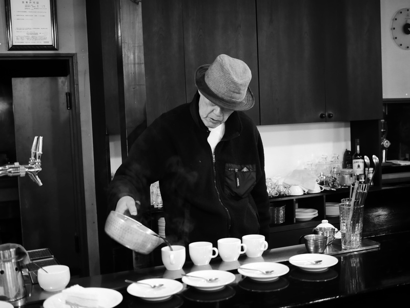 coffee cup, food, container, hat, lifestyles, one person, human, saucer, cafe, holding, meal, cafeteria, business, 4K, standing, waist up, travel, black
