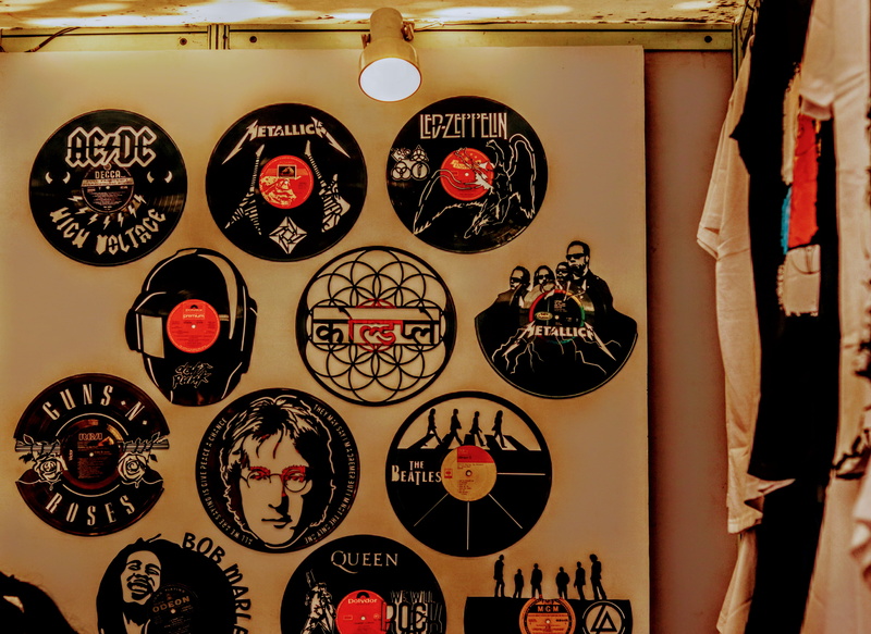 floral pattern, variation, label, indoors, large group of objects, hanging, choice, wall - building feature, disk, craft, shape, trademark, clothing, retail display