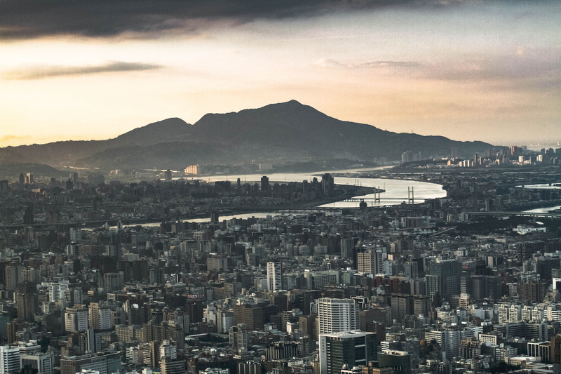 outdoors, dusk, building exterior, architecture, building, cityscape, sky, built structure, moody, skyscraper, landscape, high angle view, mountain, crowded
