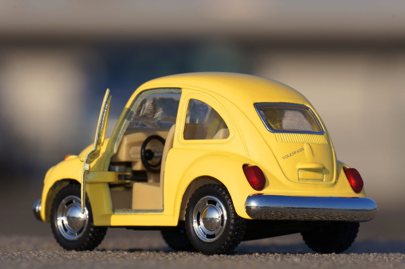 focus on foreground, taxi, wheel, miniature, asphalt, small, die, land vehicle, travel, bright, floor, pavement, motor vehicle, auto, design, vehicle, yellow