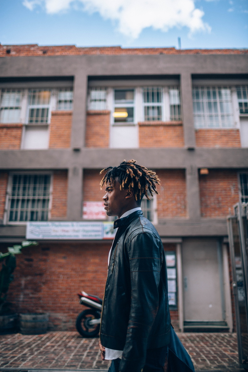 standing, one Man Only, 5K, outdoors, looking away, men, man in black, copy Space, contemplation, built structure, focus on foreground, city Life, males