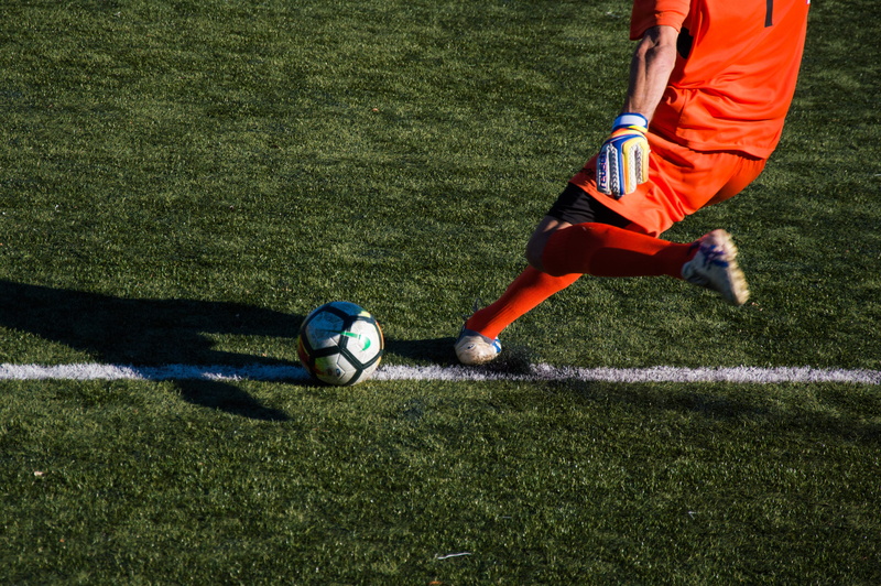 soccer player, soccer, shadow, goalkeeper, skill, person, motion, people, male, composition, sports equipment, outdoors, plant, turf, team sport, sports uniform