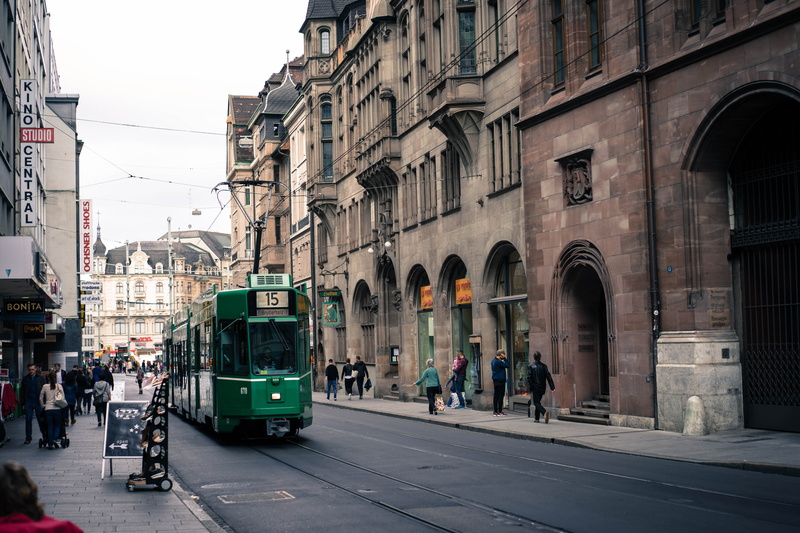 architecture, outdoors, city, building exterior, cable car, city street, day, town, built structure, track, switzerland, public transportation, group of people