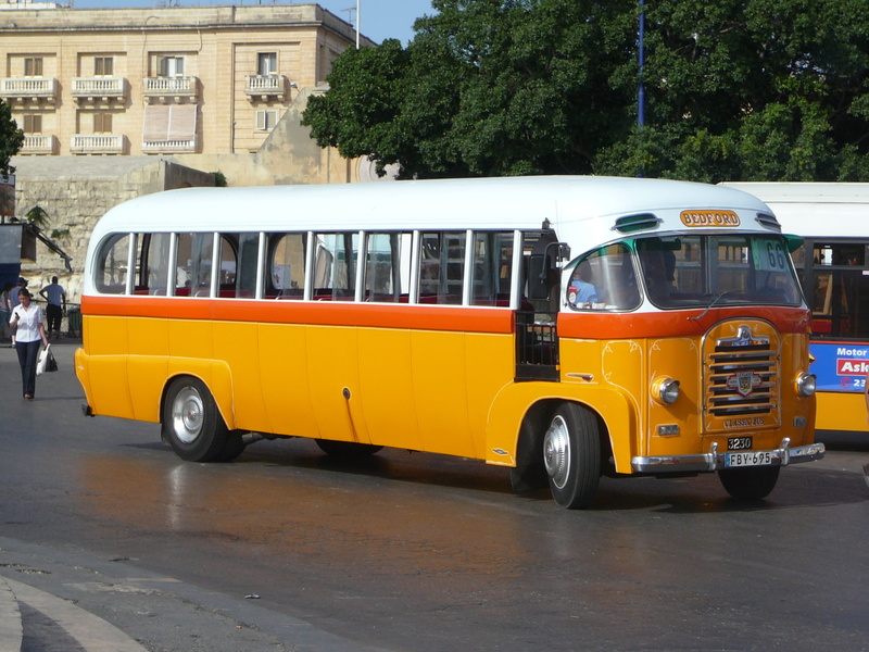built structure, architecture, yellow, malta, classic, mode of transportation, road, mode of Transport, tree, van - vehicle, motor vehicle, city, trip