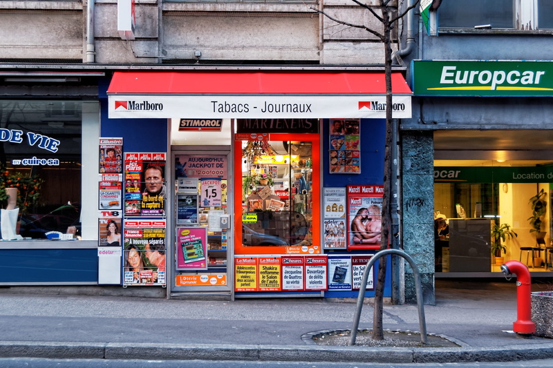store sign, advertisement, communication, script, sign, switzerland, text, road, architecture, gare, built structure, retail, store, incidental people