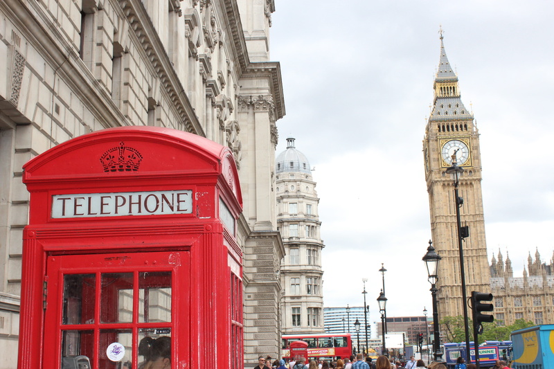 western script, sky, building, text, double-decker bus, tourism, architecture, clock tower, telephone, built structure, red, telephone booth, cabin, clock