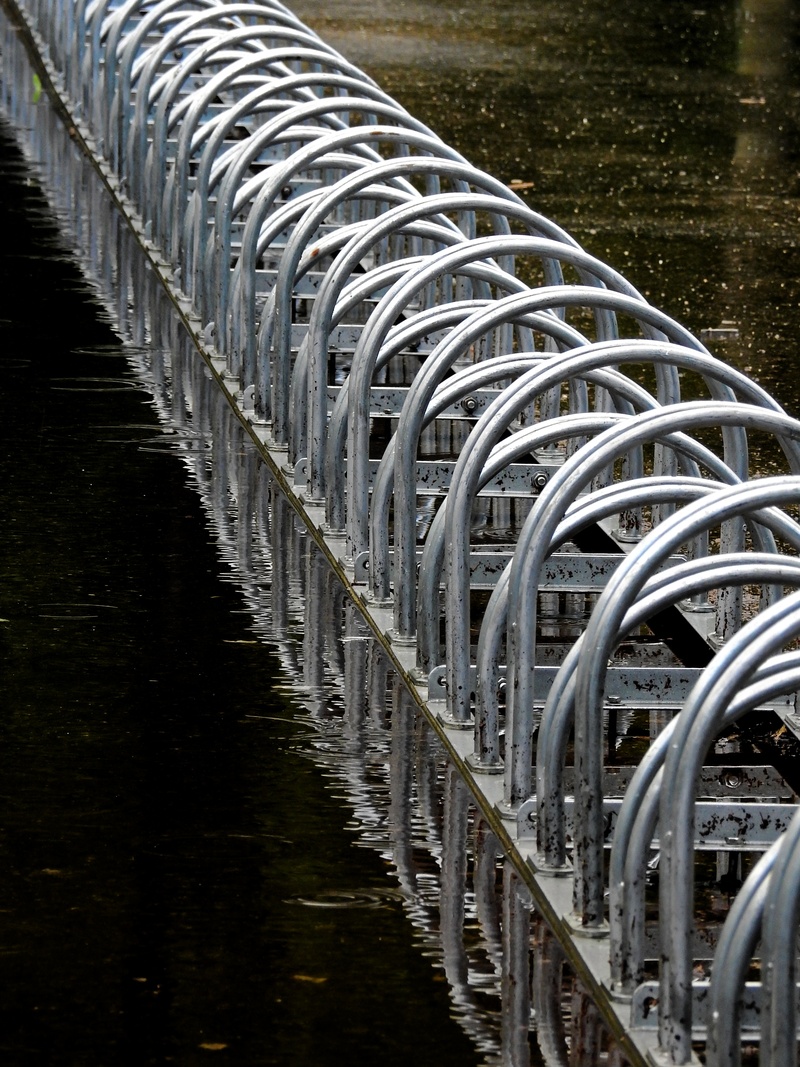 railing, security, wheel, waterfront, nature, reflection, transportation, two wheeled vehicle, water, absence, river, metal, connection, no people, lake