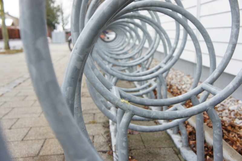 shape, in a row, pattern, bicycle rack, street, circle, steel, stand, bicycle, metal, built structure, no people, bike racks, transportation, building