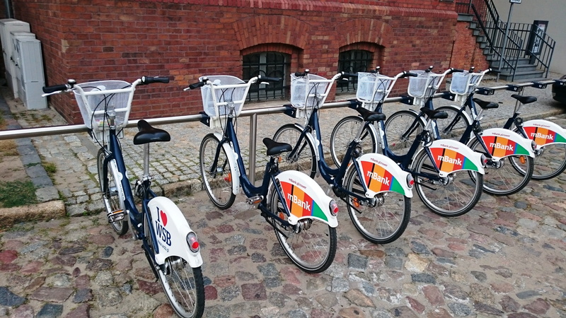 mode of transport, brick, luggage rack, stationary, bicycles, inner tubes, steering wheel, Communication, Bike, footpath, building, no people, Transport