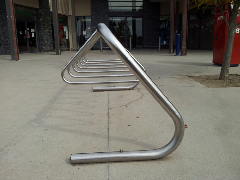 stainless, rack, diminishing perspective, the way forward, day, railing, built structure, bike parking, building, no people, city, in a row, silver colored