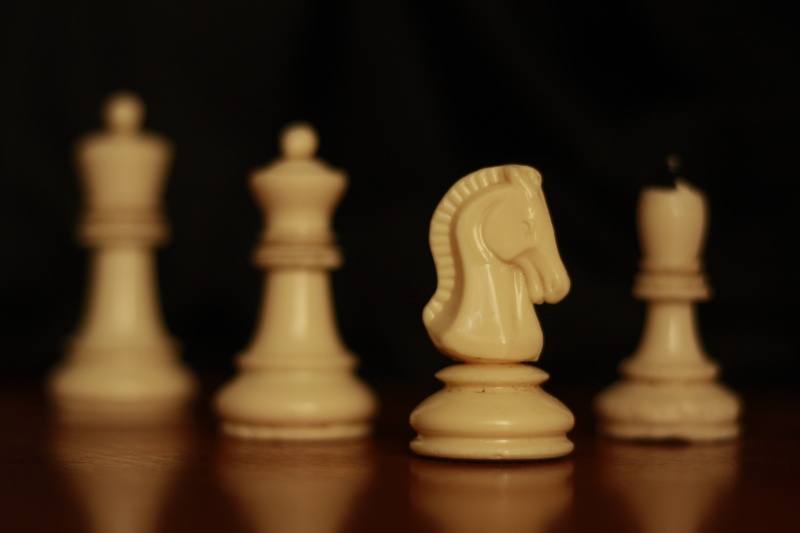competition, wood - material, board, close-up, group of objects, skill, chess, board game, play, chess piece, black background, brown, horse, indoors, strategy